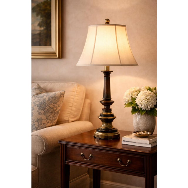 Striking tall neoclassical-inspired column table lamp featuring a dark fluted shaft with brass accents and sculptural...