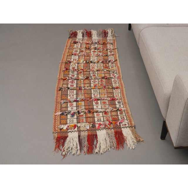 Vintage Hand-Knotted runner rug is a semi-antique vintage area rug. The '70s Eastern region of Anatolia's unique rug is...