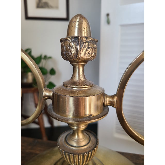 Dazzling mid-century table lamp crafted from brass with two globe shades. Features a lovely scrolling, double arm design...