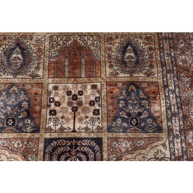 A vintage Egyptian handmade silk rug dating back to 1980. The main field features a mosaic-like composition, containing...