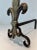 This pair of andirons is composed of a bronze fleur-de-lys and wrought iron. Yjis is a French work. Circa 1940