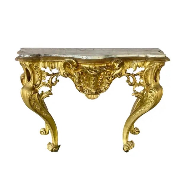 French Louis XV Style Giltwood Console Table with Marble Top. Table features a dramatic deep serpentine front and sides,...