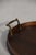 Early 20th Century oval wooden tray with brass handles and a refined inlaid center, finished in a deep, time-worn tone....