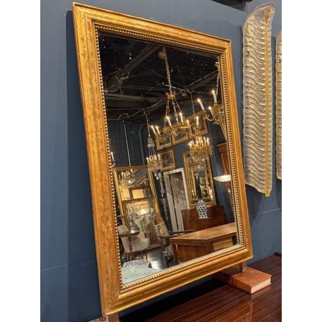 19th century French transitional giltwood mirror. Transitional French mirrors blend elements of Louis XVI neoclassicism...