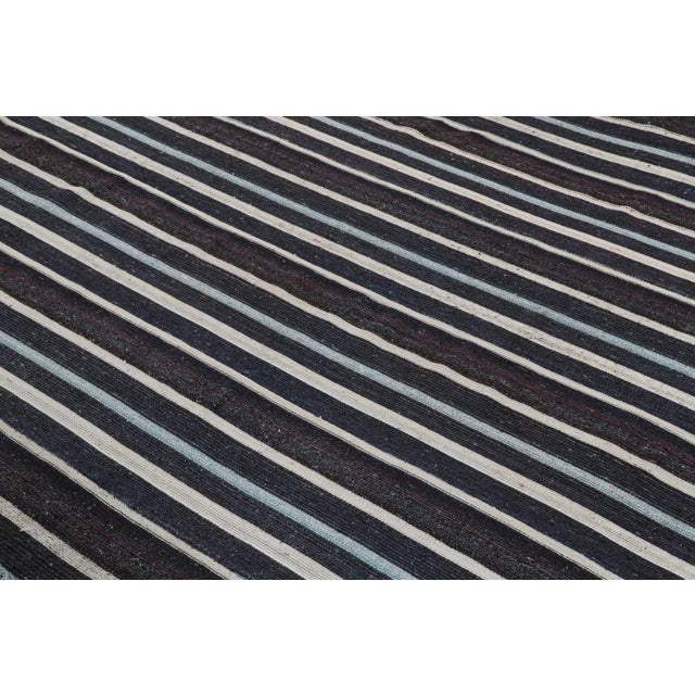 Originating from Turkey in the 1950s, this vintage mid-century wool kilim hails from a distinct family of contemporary...