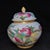 A beautiful pair of Chinese Famille Rose porcelain covered jars. The white ground is finely hand-painted with vibrant pink...