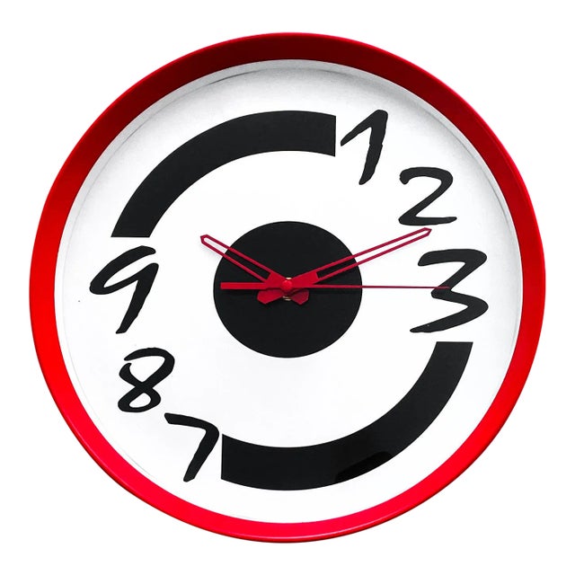 A super fun new old stock 1980s or 1990s clock. Red case, white face with stylized black numbers, and red hands. In very...