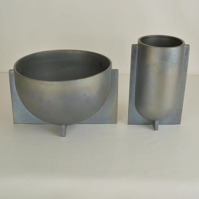 Pair of decorative sculptural vases with soft metal blue-grey glaze in different sizes have a modern geometric shape. They...
