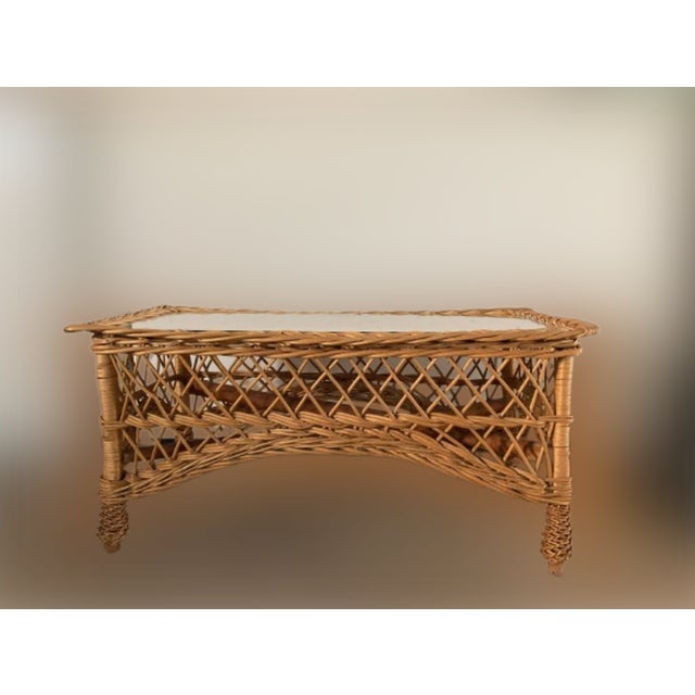 Beautiful Mid-Century rectangular bamboo and rattan dining or living room side table with glass top. Produced during the...