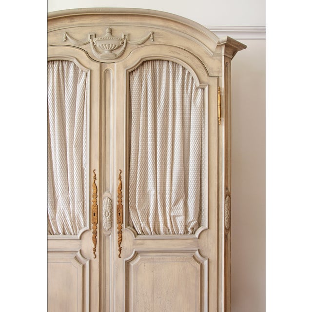 Commanding in both scale and craftsmanship, this monumental French Provincial style armoire blends classic European...