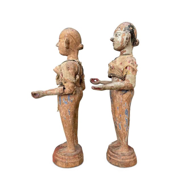 A pair of Indonesian wooden sculptures from the late 1700s depicting two women in carved and lacquered wood with extensive...