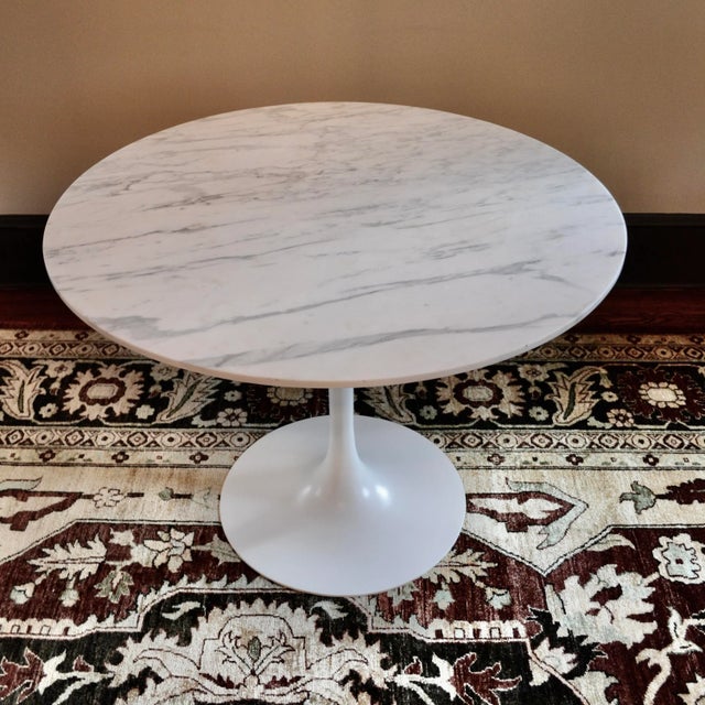 Modern tulip table in the style of Saarinen, possibly by Burke. White painted base. Antique piece of Calacatta / Statuary...