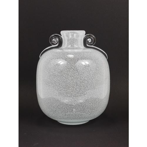 An impressive and solid art glass studio vase featuring two decorative snail-shaped handles, dated circa 1950s....