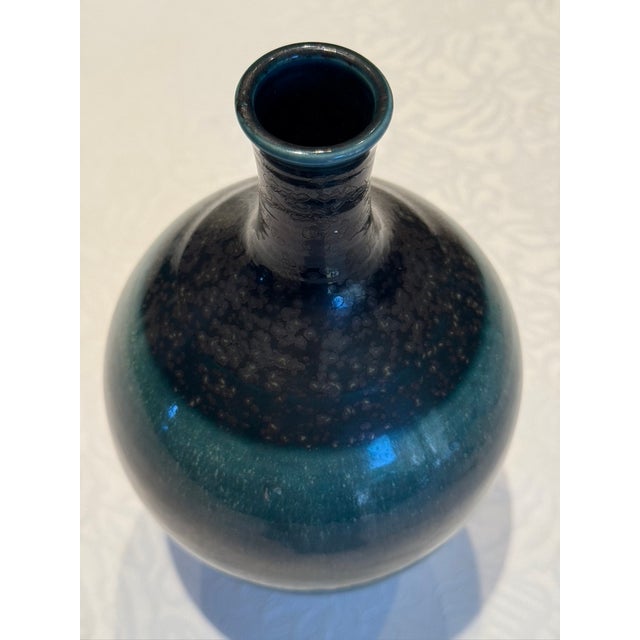 An exceptional piece of mid-century Japanese ceramic artistry, this sculptural porcelain tokkuri form originates from the...