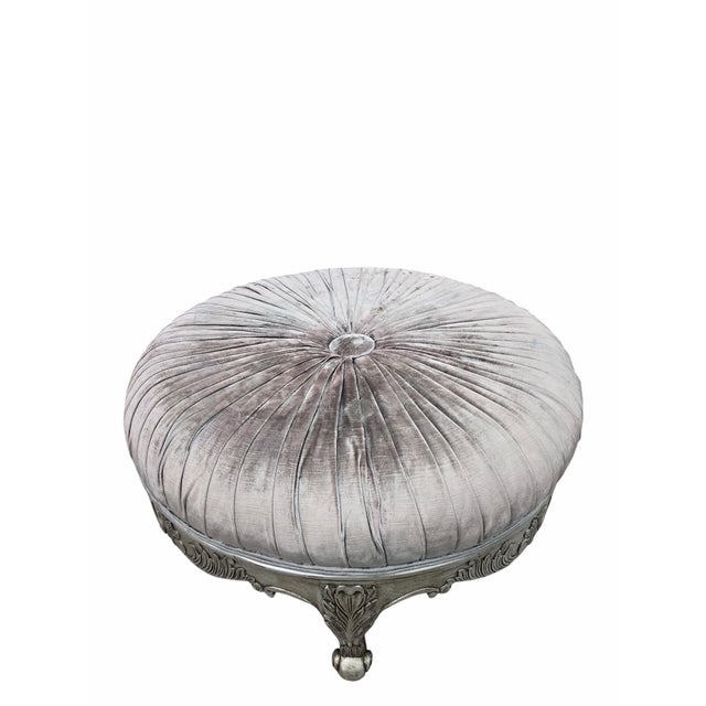 Hollywood Regency Carved Round Ottoman with Pleated Velvet Upholstery An elegant Hollywood Regency-style round ottoman...