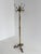 Elegant vintage brass coat rack featuring a rotating crown, decorative cast brass detailing, a fluted column, and a...