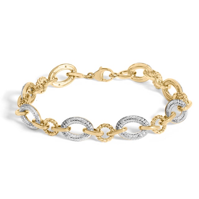 Glimmer with quiet sophistication in a bracelet that marries warmth and light. Alternating polished yellow oval links and...
