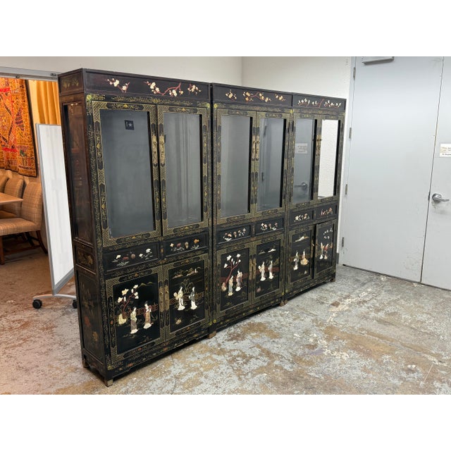 Design Plus Gallery presents a Set of Three Chinese Display Cabinets. The tall lacquered cabinets showcase traditional...