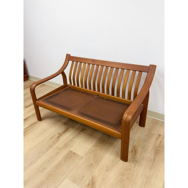 This cognac-toned bench captures the sculptural, organic quality that defines Danish Modern design, offering a two-seat...