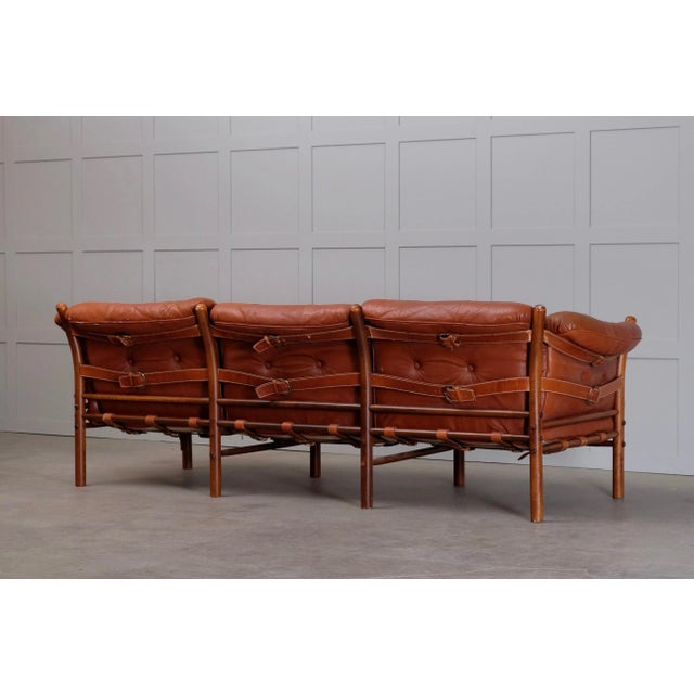 Three-seat. Black leather, brass, stained beech. In need of new uppholstery. Design by Arne Norell, produced by Arne...