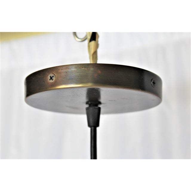 A Custom designed Solid Brass Pendant by a well known Artist . Custom made from solid brass materials ,and with an Antique...