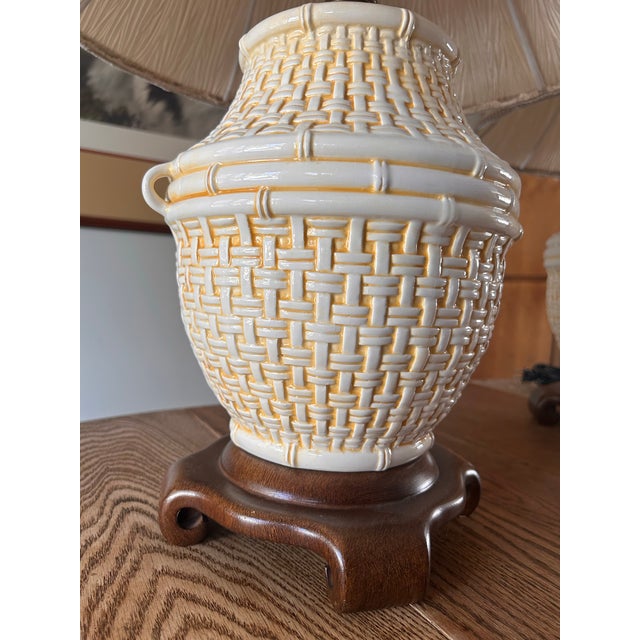 A pristine pair of vintage Wildwood Accents Ceramic table lamps. Cream and yellow glaze on chinoiserie style rattan...