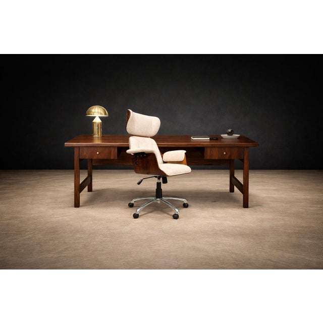 A study in proportion and restraint, this Brazilian modern desk from the 1960s distills function into architectural...