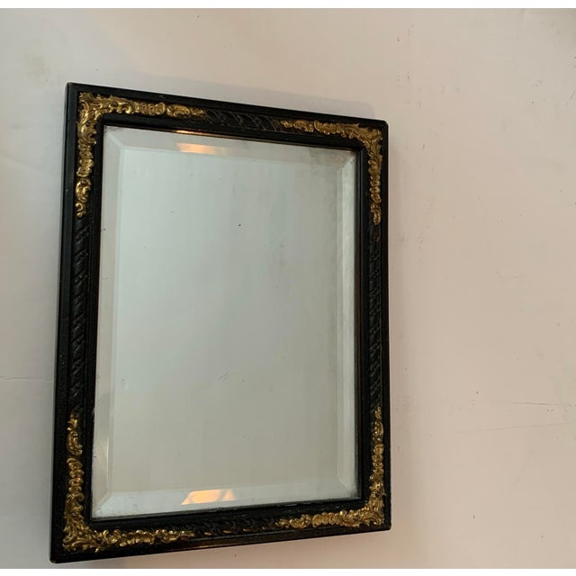 A petite, antique mirror with the charm of a French flea market find. Its late Victorian ebonized frame with subtle gilt...