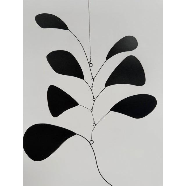 Alexander Calder, renowned for his mobiles and kinetic art, brings playful precision and dynamic balance to Skogen är det...