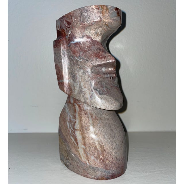 Carved from beautiful and finely patterned marble. Resembling ancient Polynesian statues of Moai on Easter Island is seen...