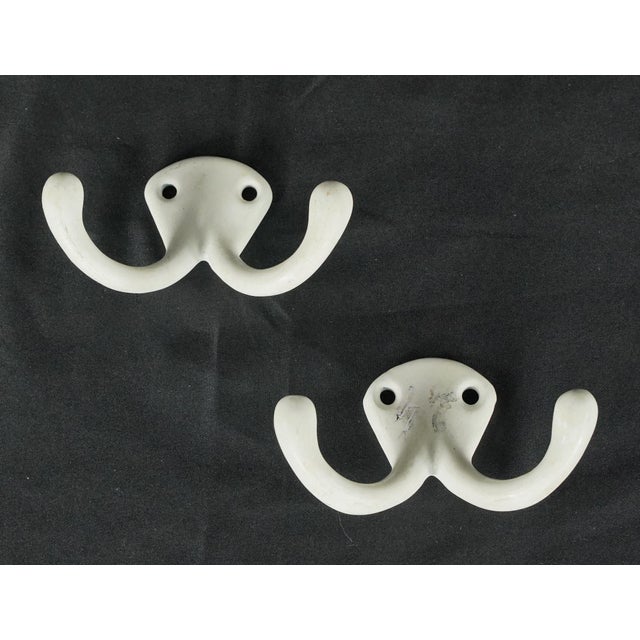 Vintage European double arm wall hooks made of white ceramic. The original mounting screws are not available. Good...