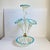 A Victorian blue vaseline glass epergne, having a central stem and three lily form trumpets with turquoise blue petals...