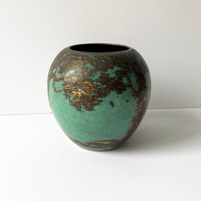 Rare WMF Ikora metal rounded vase from the 1930s. The patinated turquoise green metal contrasts beautifully with the gold...