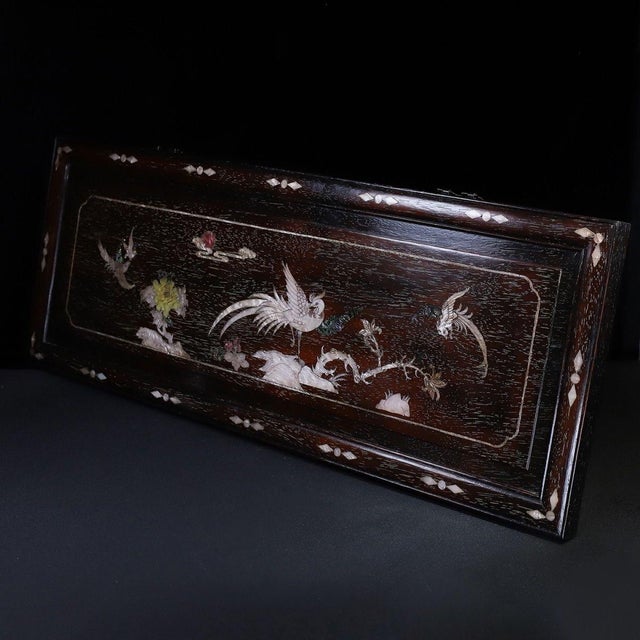 A striking and large Chinese horizontal wall plaque crafted from dark Zitan wood. The plaque is beautifully decorated with...