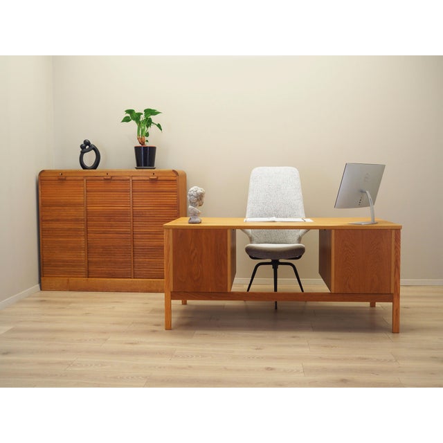 The desk was made in the 1970s, Norwegian production. The structure and the top of the furniture are covered with ash...