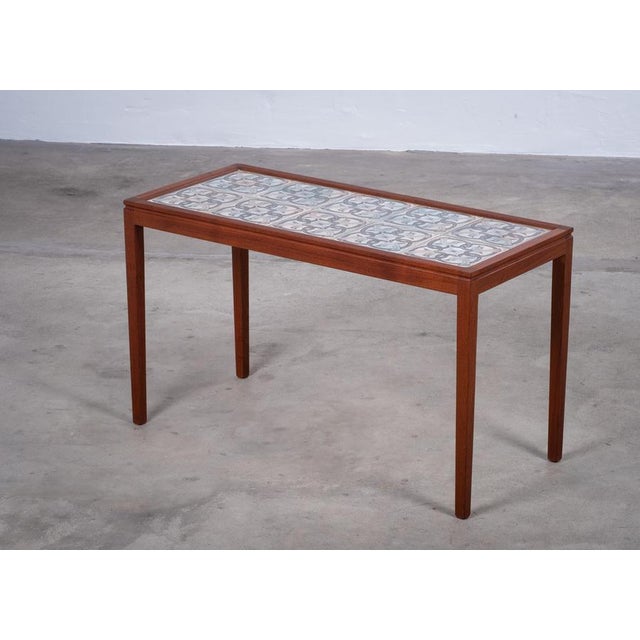 Elegant rectangular coffee / side table designed and produced in Denmark during the 1960s. Crafted in teak and featuring a...