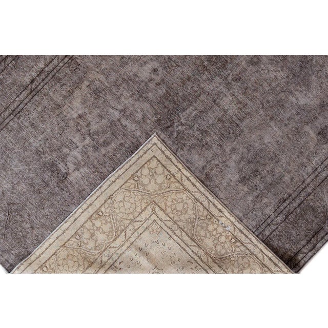 Vintage hand-knotted distressed rug with a medallion design. This rug measures 9'8" X 13'8".