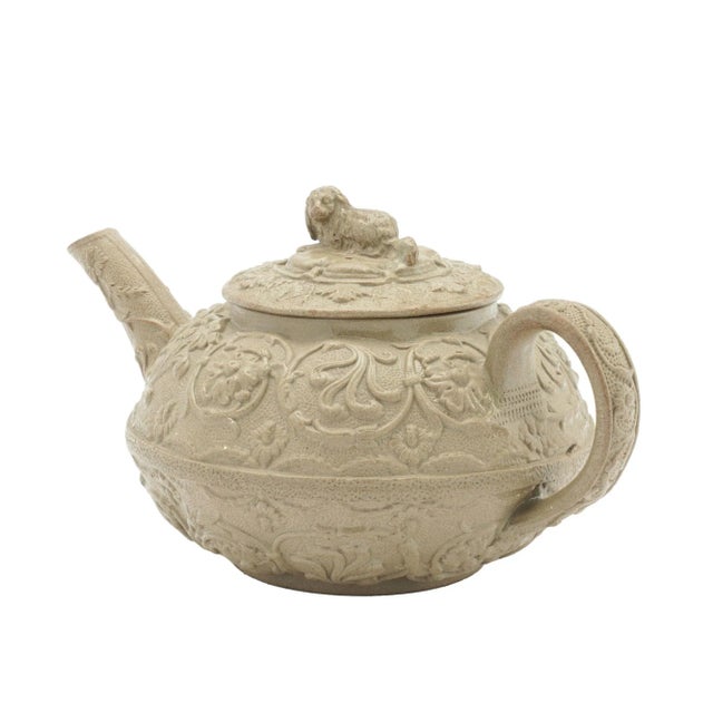 Slip cast stoneware teapot in a putty colored smear glaze. The teapot features a spaniel finial and heavy Renaissance...