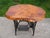 Very nice antique cast iron Singer treadle sewing machine base with nice older live edge cedar wood top. The table is...
