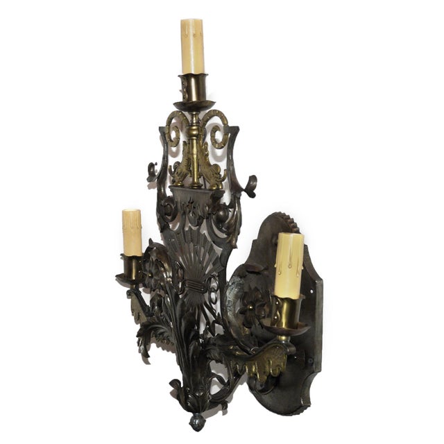 Striking circa 1925 Art Deco style Bronze and forged Iron three light sconce, having exuberant foliate and floral...