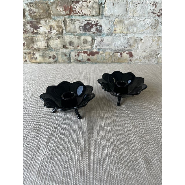Add a touch of sculptural elegance to your space with this striking pair of vintage black glass candle holders. Shaped...