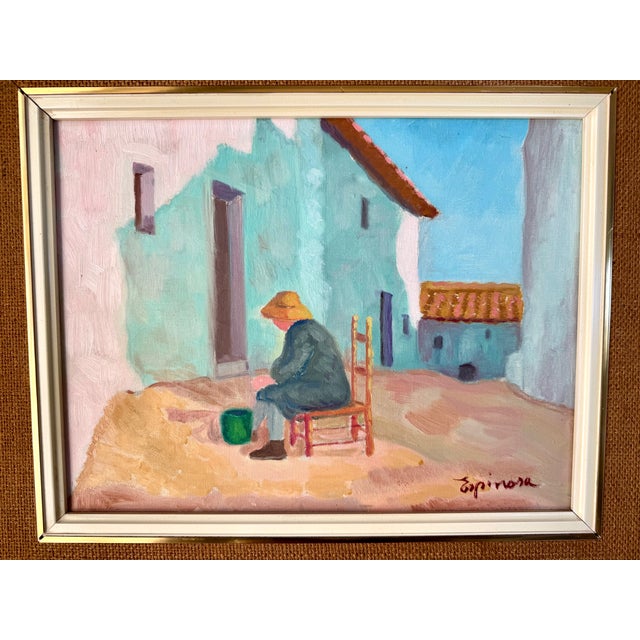 The painting is a bright, expressionistic oil painting of a village scene with a seated figure on a reddish chair in front...