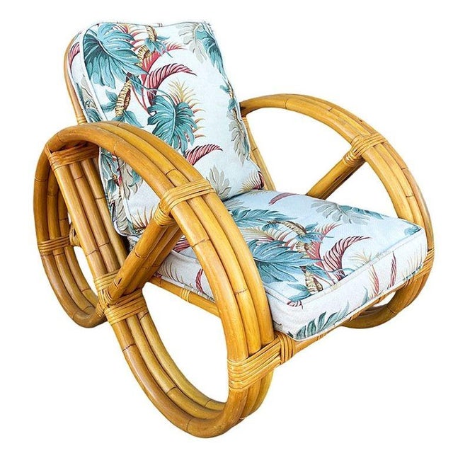 Pair of beautifully restored rare 3-strand round full pretzel arm rattan lounge chairs. Each with fancy wicker wrappings....