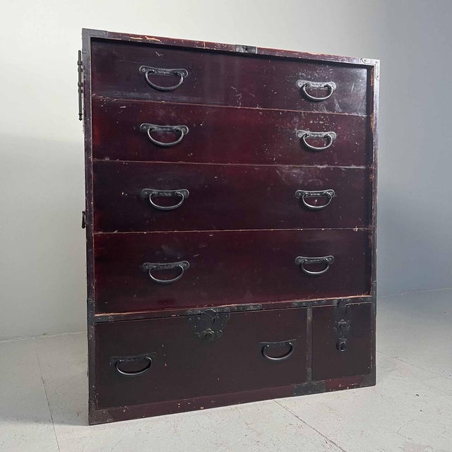 Dark deep red Isho-Dansu Tansu one-piece chest of drawers with six drawers. This 19th century cabinet is definitely still...