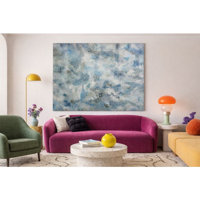 A striking original abstract painting by Mona Oman, featuring layered blue, gray, and soft white tones with intricate...