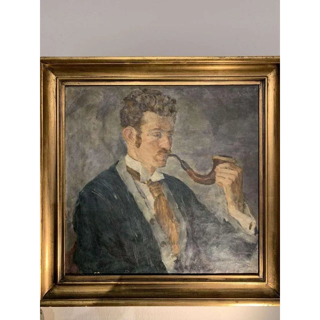 Charming circa 1920's framed oil painting of a gentleman wearing shirt, tie and waistcoat beneath a blue jacket smoking a...