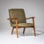 Pair of lounge chairs on finely crafted polished oak frames featuring broad, gently flattened armrests. The seats have...