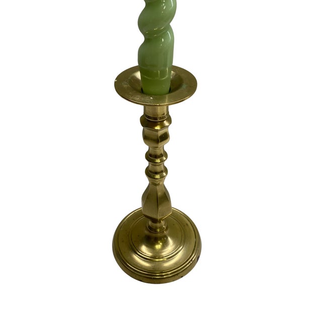 A substantial vintage brass candlestick distinguished by its impressive scale and classic baluster-form silhouette. The...