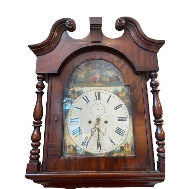 A striking mahogany grandfather clock that commands attention in any room. This substantial timepiece features rich, warm...
