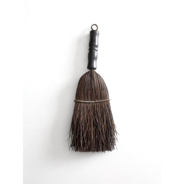 Antique hand broom from the late 19th to early 20th century, featuring natural bristles bound with wire and a turned...